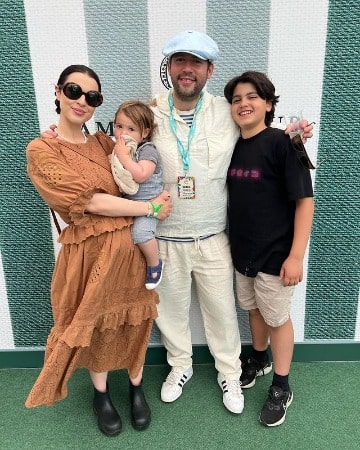Picture of Matilda Sturridge in a brown one-piece with her Husband, Ollie Rosenblatt and children 